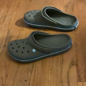 Grey Crocs with blue and white stripes on the side size 10 men’s